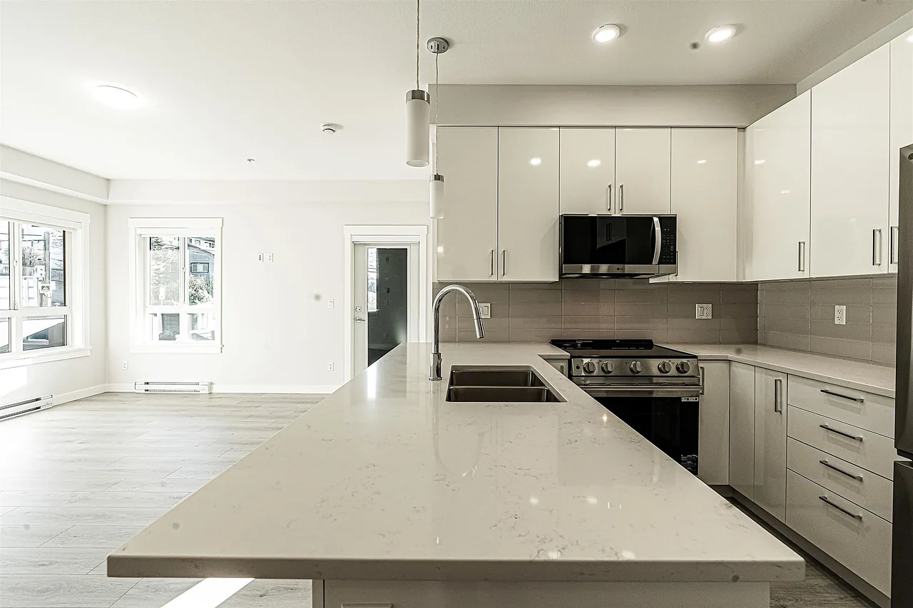 Modern kitchen with white cabinets and a quartz island