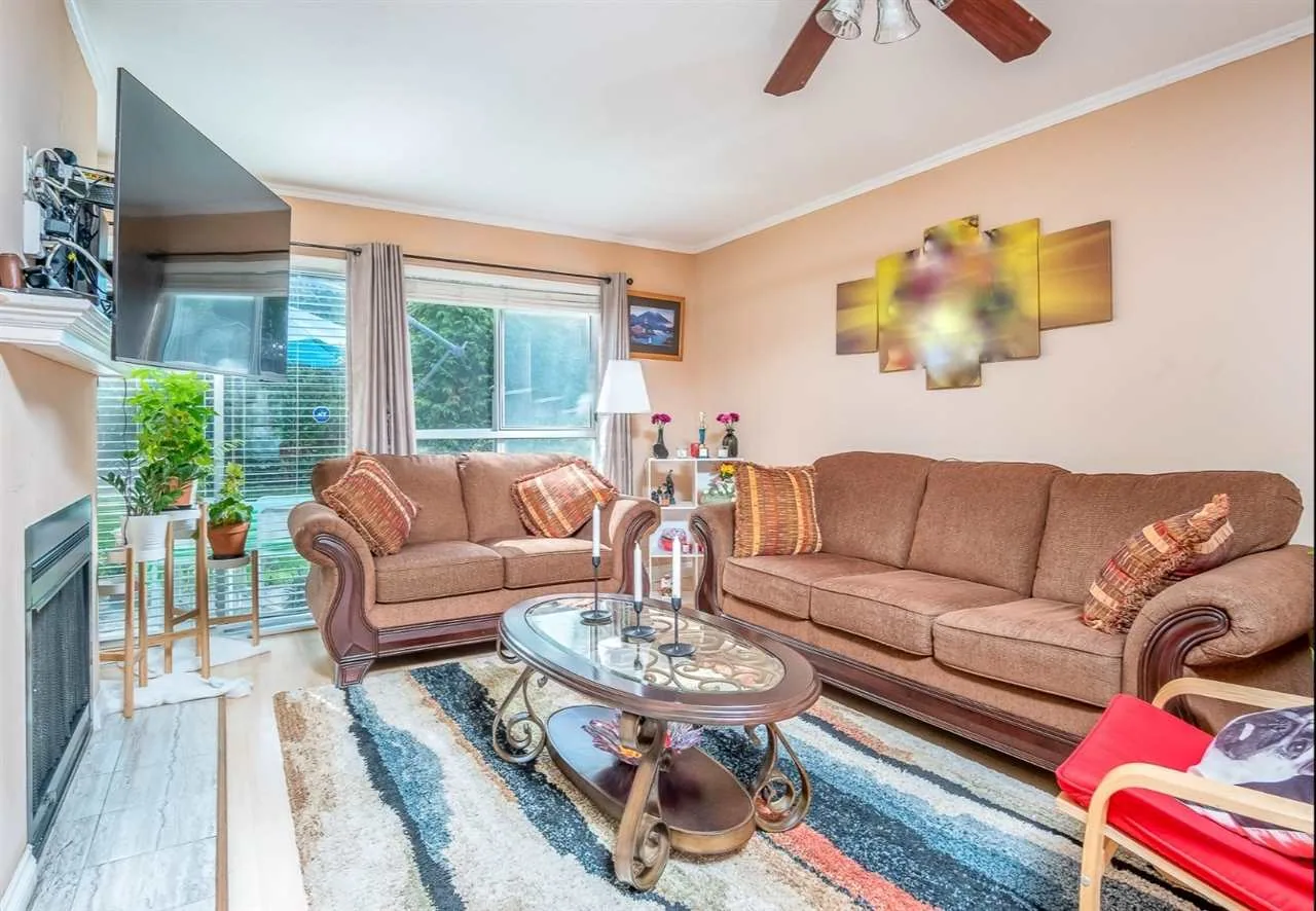 Living room with a sofa, patterned rug and large window