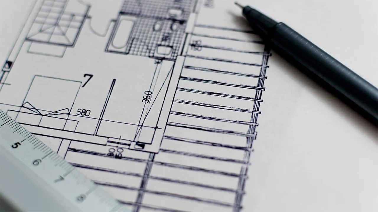 Architectural floor plan drawing with a pen