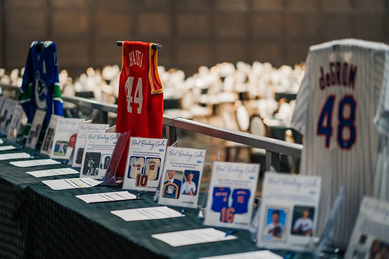 Charity auction table with signed sports jerseys