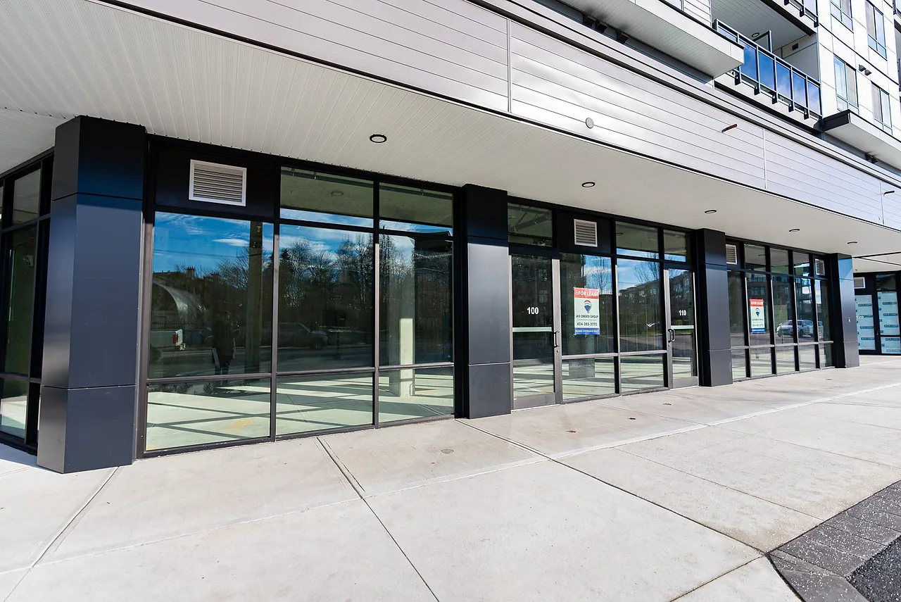 Glass storefront units at the base of a modern building